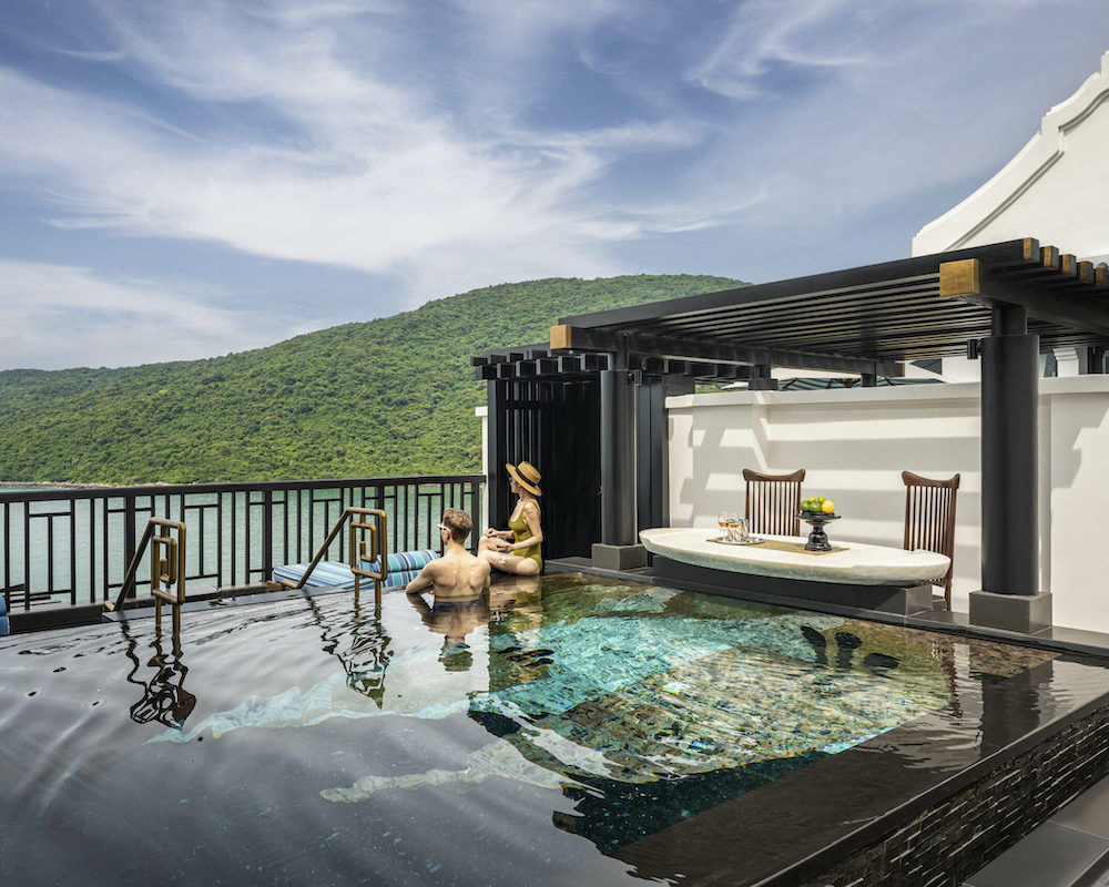 a couple in a private plunge pool at a luxury hotel in Vietnam