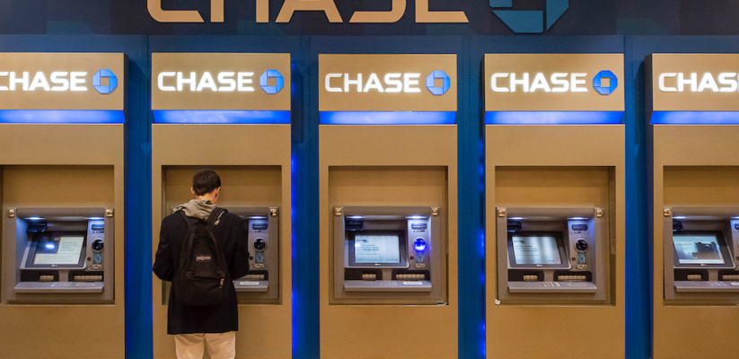 a person using one of many ATMs in a row at a Chase bank