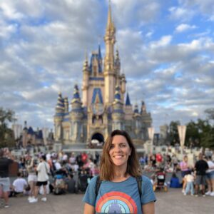 Samantha Holland in front of the Magic Kingdom Disney castle