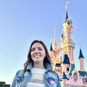 Samantha Holland in front of the Paris Disney castle