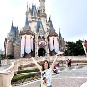 Samantha Holland in front of the Tokyo Disney castle