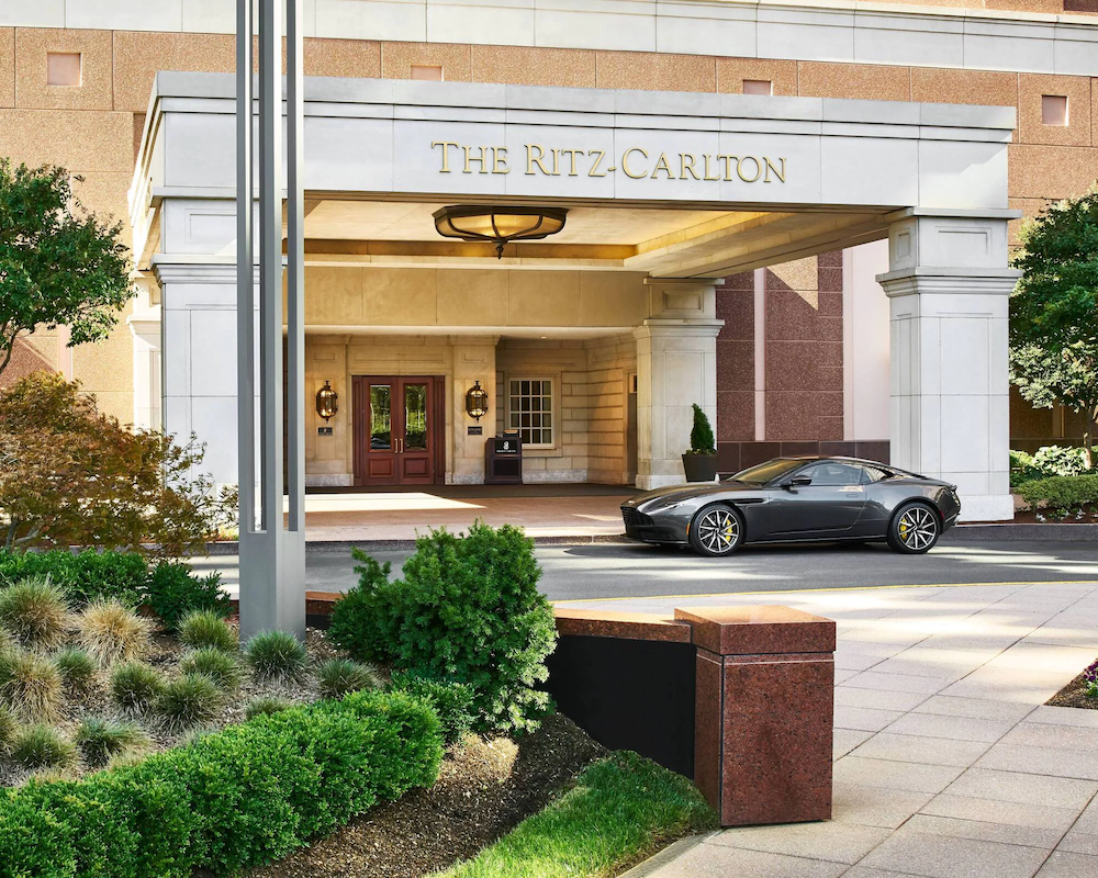 The Ritz-Carlton Tysons Corner entrance with a fancy sports car parked in front