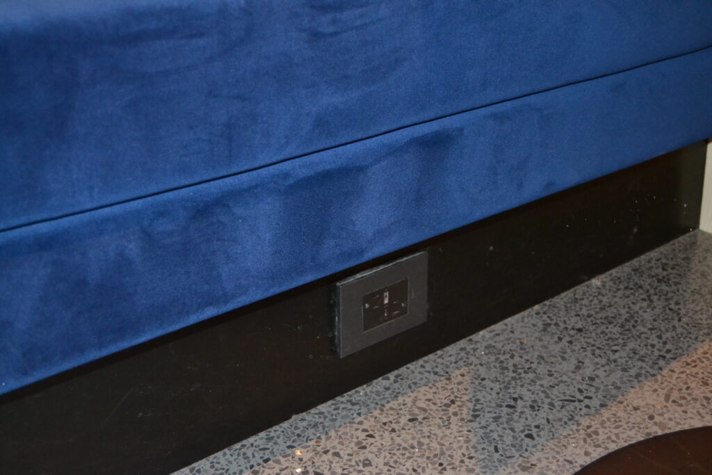 plug at the bottom of a bench inside the Chase Sapphire Lounge LGA
