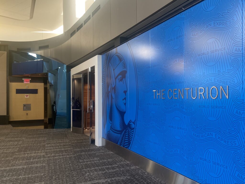 Lounge entrance in LGA located next to large Centurion Lounge sign