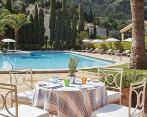 A photo of the pool from a dining table at La Residencia, A Belmond Hotel in Mallorca, Spain and an Amex FHR.