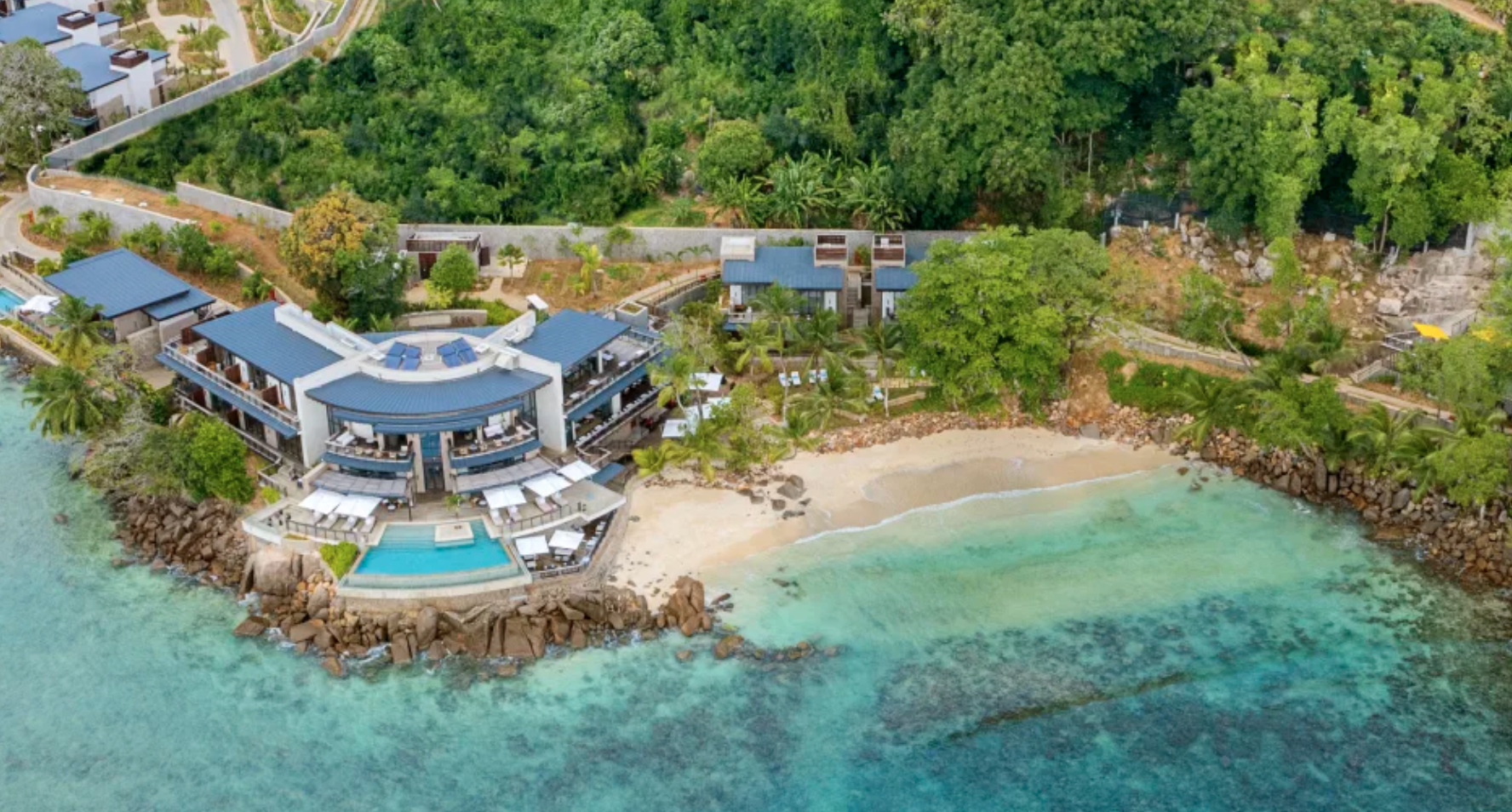 The beach outside a Hilton luxury hotel, the Mango House Seychelles, LXR Hotels & Resorts.