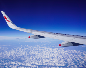 a wing and wingtip showing Avianca branding as seen from a plane window in flight