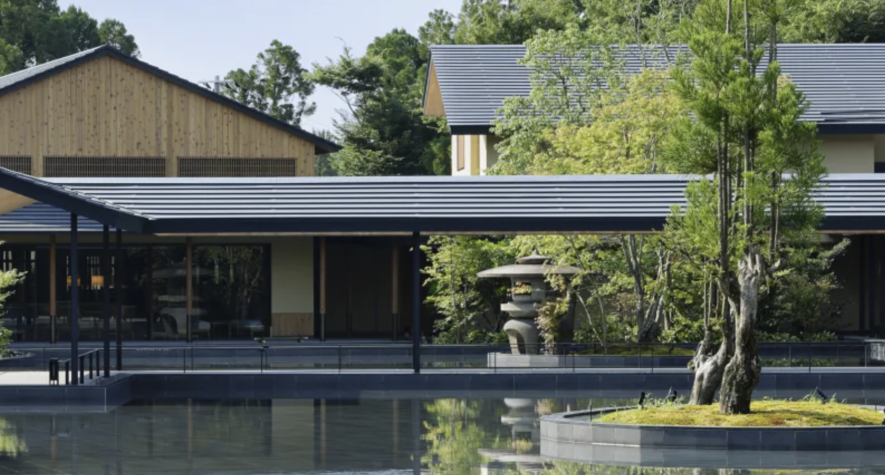 Exterior walkway by a pond at the ROKU KYOTO, LXR Hotels & Resorts.