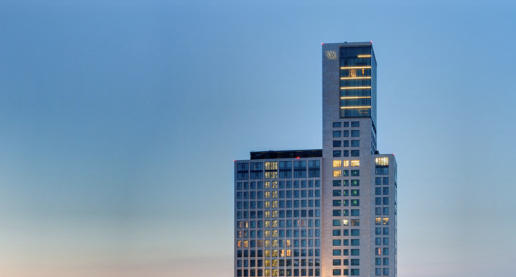 Exterior of the Waldorf Astoria Berlin at dusk.