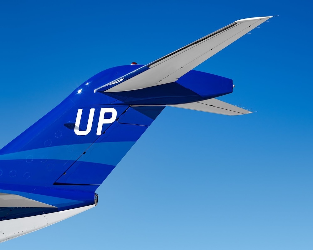 Wheels Up Plane Tail with a blue sky backdrop