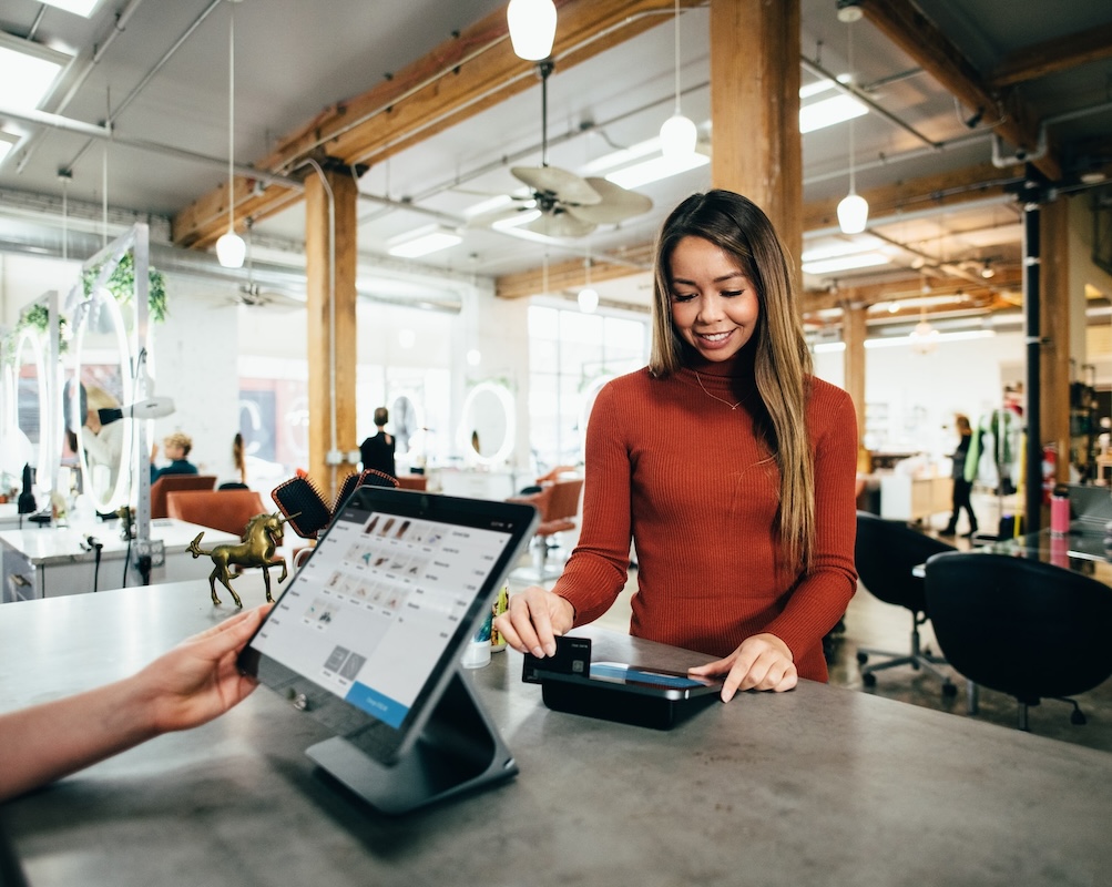 Woman paying for purchases at store