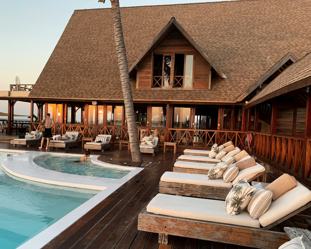 a hotel pool flanked by lounge chairs