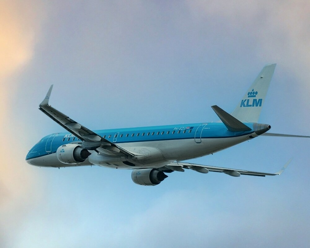 KLM E175 taking off at dusk.