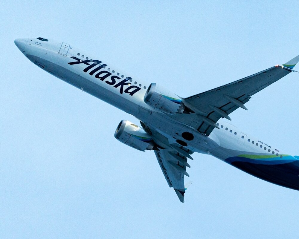 Alaska Airlines 737 taking off in cloudy skies.