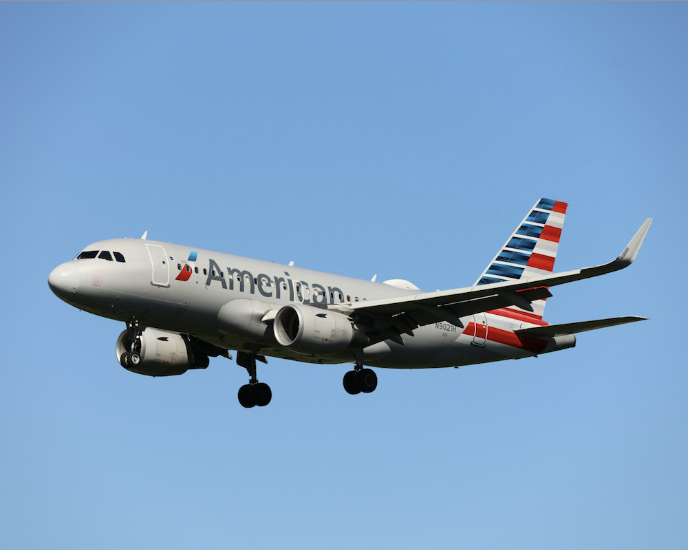 American Airlines A319 with a blue sky backdrop.