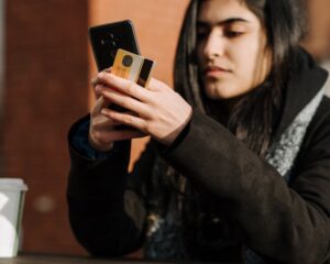 woman with phone and credit card