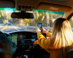 a passenger in the front seat of a car takes a picture of the road ahead