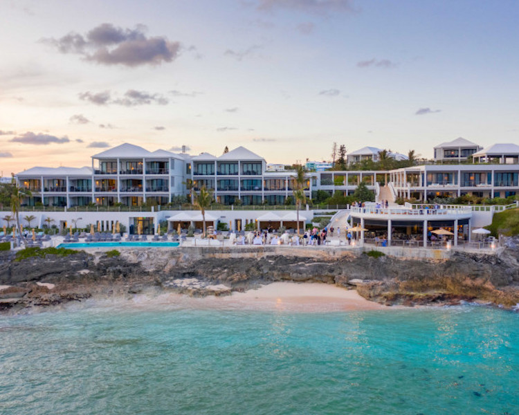 view from the beach to the pool deck and rear of the hotel at The Loren at Pink Beach in Bermuda.