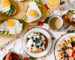 Breakfast spread with eggs, waffles and drinks
