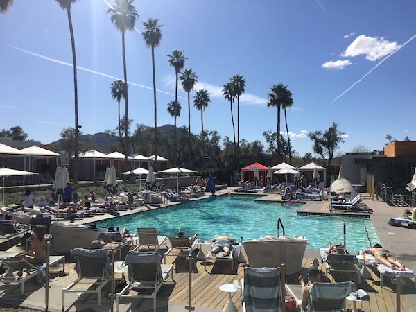people laying around a hotel pool