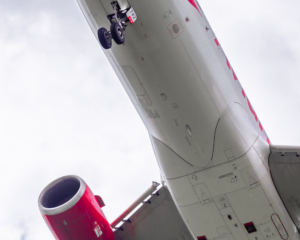 looking up at the underside of an Avianca plane flying overhead