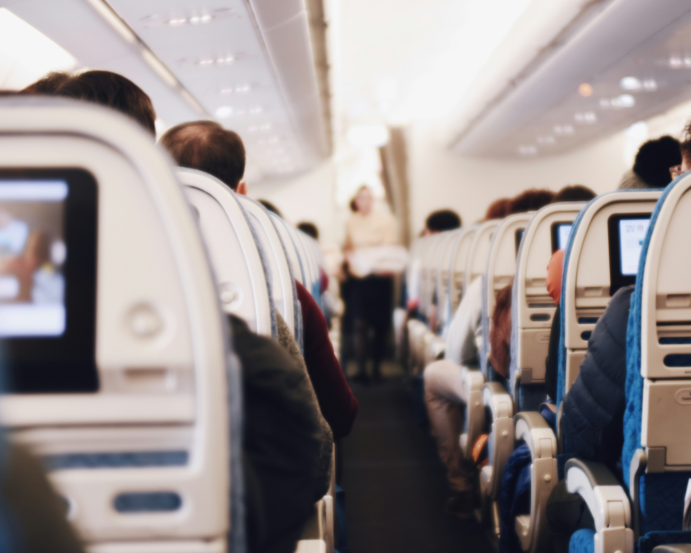 looking up the aisle in a plane full of passengers