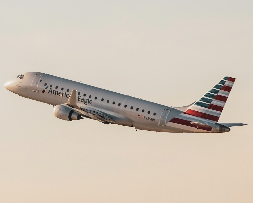American Airlines plane taking off into the sunset.