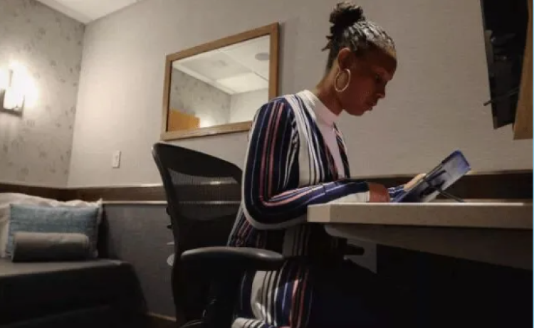 A woman works at a desk in a Minute Suite.
