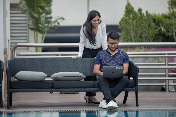 Two people look at a laptop together