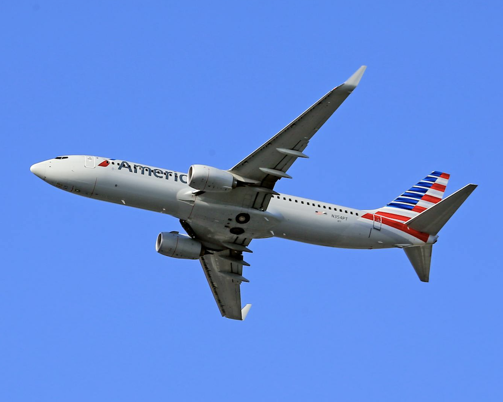 American Airlines 737 taking off in blue skies.
