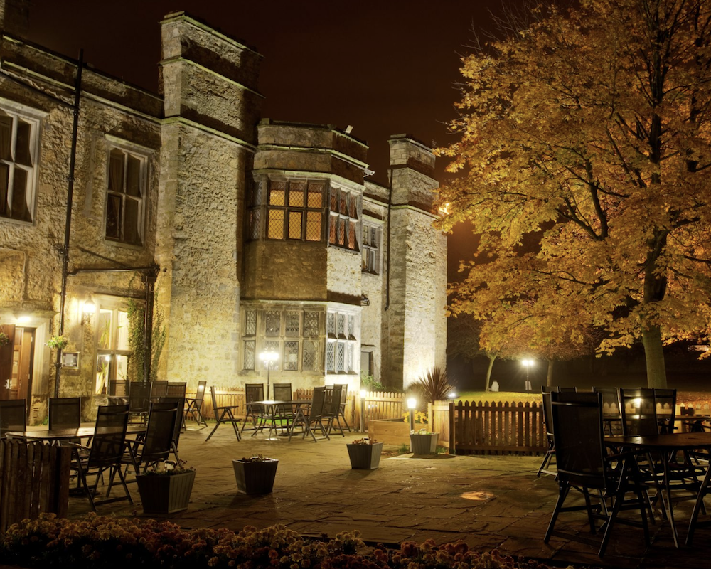 The exterior of the Walworth Castle at night.