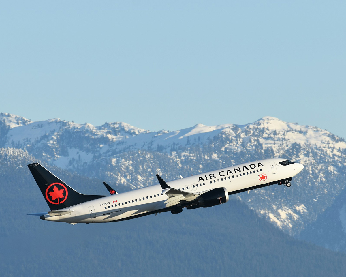Air Canada aircraft climbing steeply after take off with gear retracting -