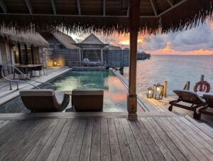 Pool deck of an overwater villa at the Waldorf Astoria Maldives