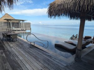 Pool deck of an overwater villa at the Waldorf Astoria Maldives