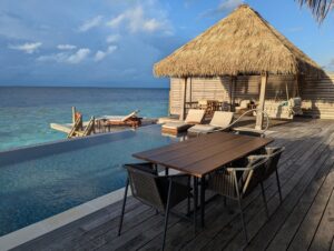 Pool deck of an overwater villa at the Waldorf Astoria Maldives