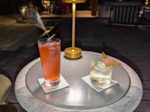 Drinks at Peacock Alley, including the bar's signature drink with a peacock feather