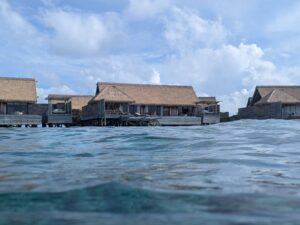 View of an overwater villa at the Waldorf Astoria Maldives from the house reef