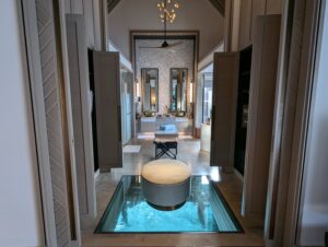 Closet area with glass bottom flooring in an overwater villa at the Waldorf Astoria Maldives