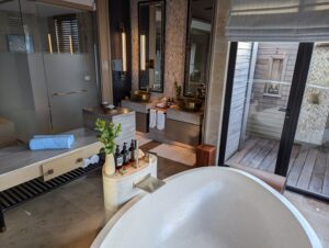 Bathroom and outdoor shower in an overwater villa at the Waldorf Astoria Maldives