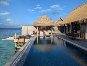 Pool deck and ocean entry from an overwater villa at the Waldorf Astoria Maldives