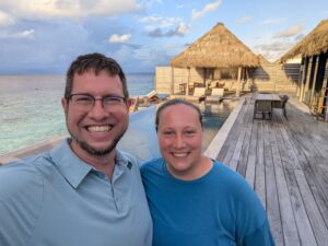 JT and Katie on the pool deck of an overwater villa at the Waldorf Astoria Maldives