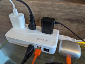 Photo of BESTEK travel converter box with almost all outlets in use