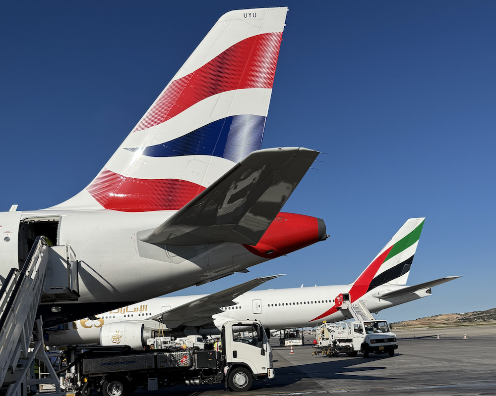 British Airways and Emirates airplane tails at Athens Airport.