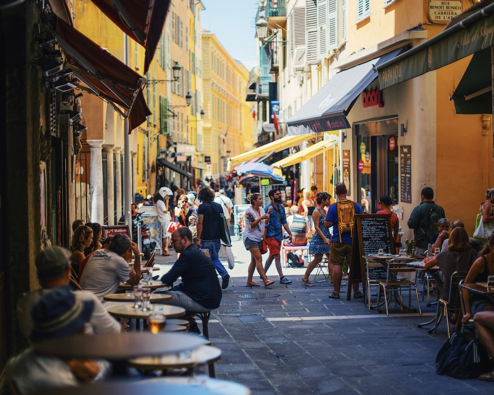 European street with dining establishments on either side.