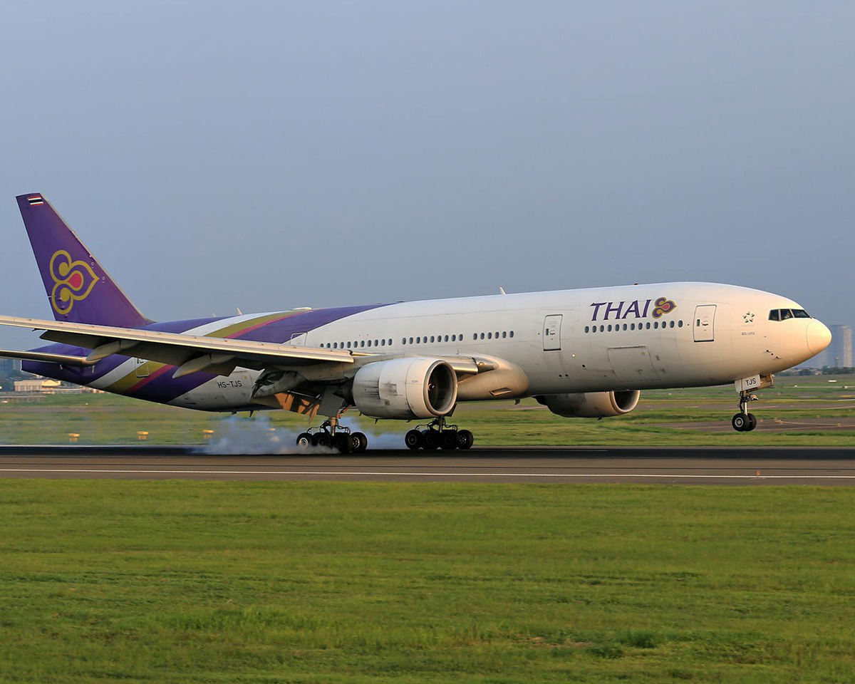 Thai Airways aircraft touching down on the runway -