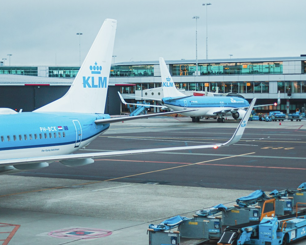 KLM airplanes parked at gates in Amsterdam.