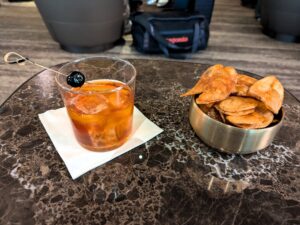 Drink and chips at the JFK Delta One Lounge