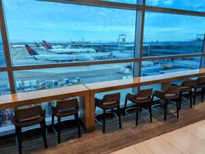 JFK Delta One Lounge seating by a window