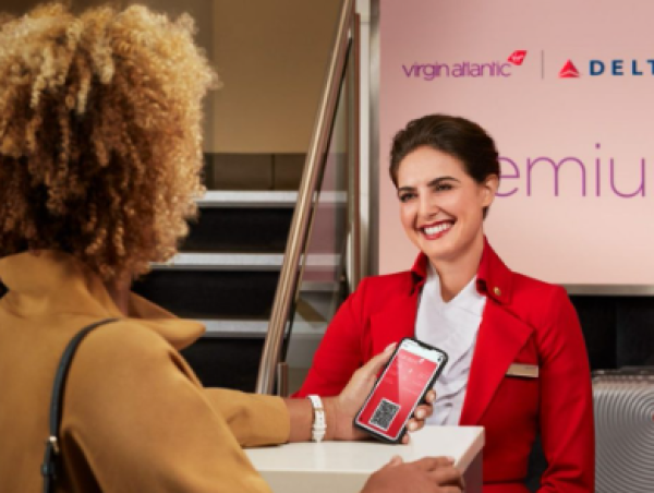A photo of a Virgin Atlantic agent checking a customer in