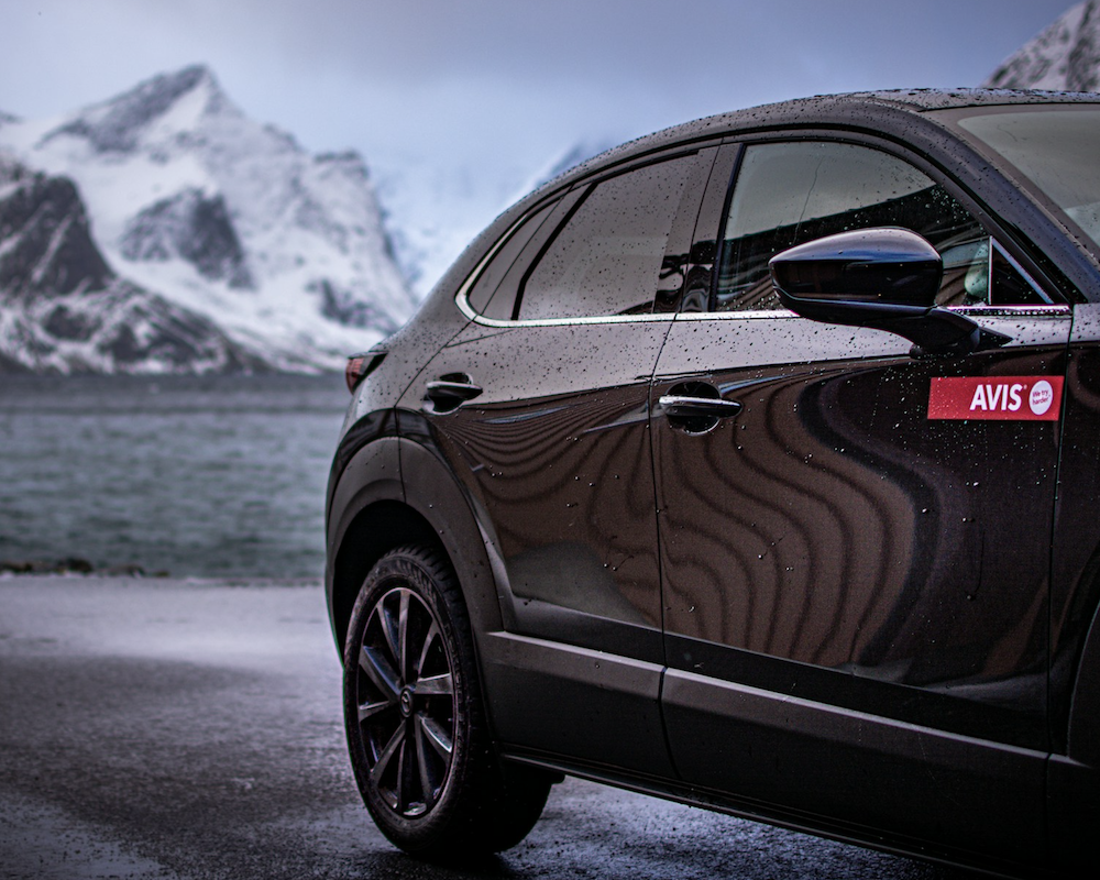 Avis rental car parked in front of a snowy mountain